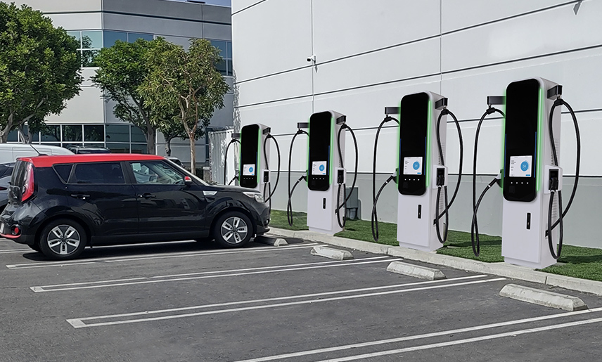 Commercial electric vehicle charging stations in a parking area