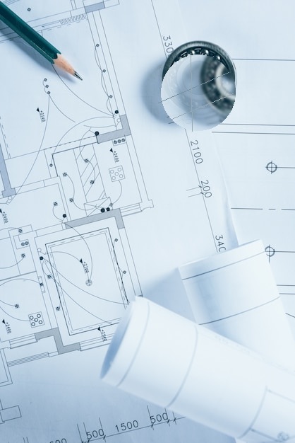Clean electrical blueprint with pencil and rolled plans