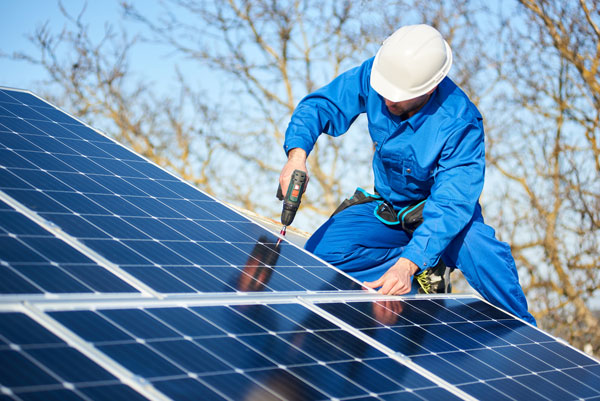 Technician installing solar photovoltaic panels